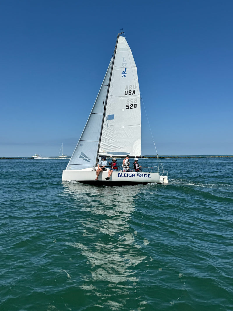 Sailboat with 'USA' and number '528' on a clear blue sky day.